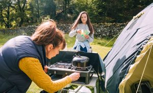 A propane or butane camp stove is one of the best ways to boil water for coffee or tea on a camping trip.