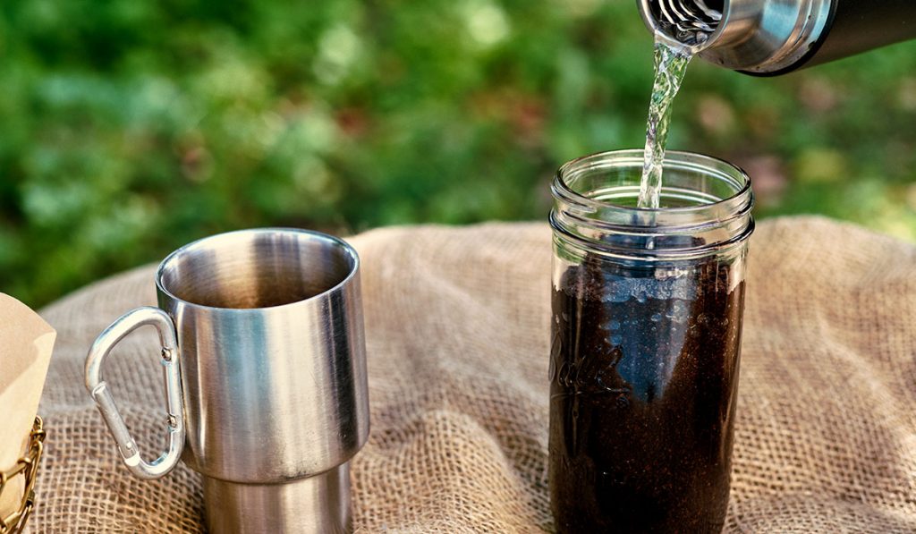 Mixing the water with light roast coffee grounds. 